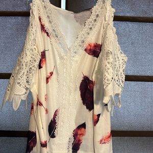 White blouse with shoulder cut outs.